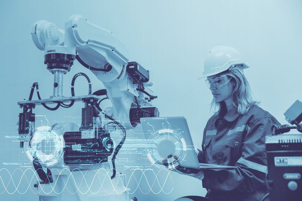 Woman working with an AI robot.